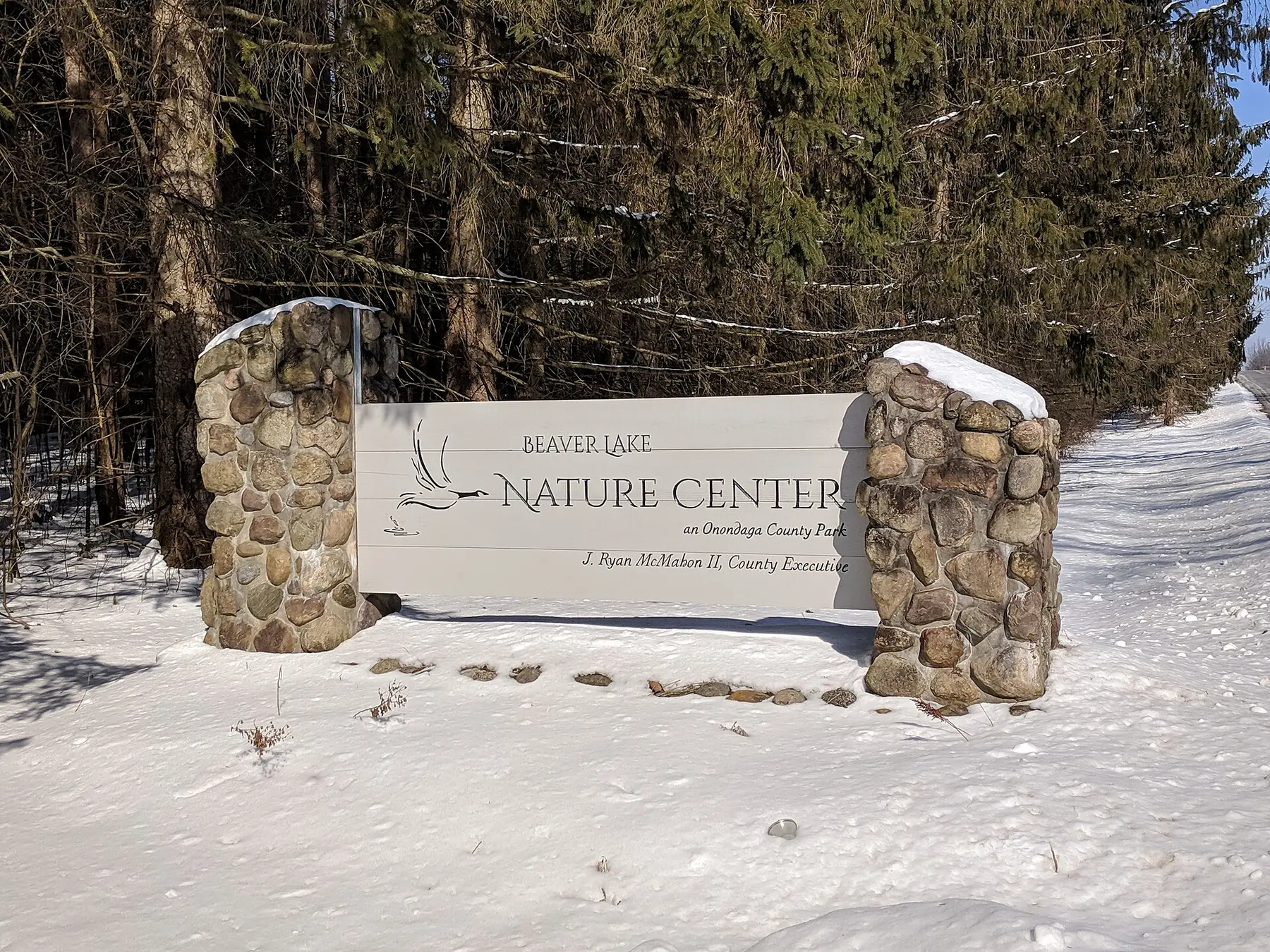 The stone entrance sign at Beaver Lake Nature Center on a bright winter day