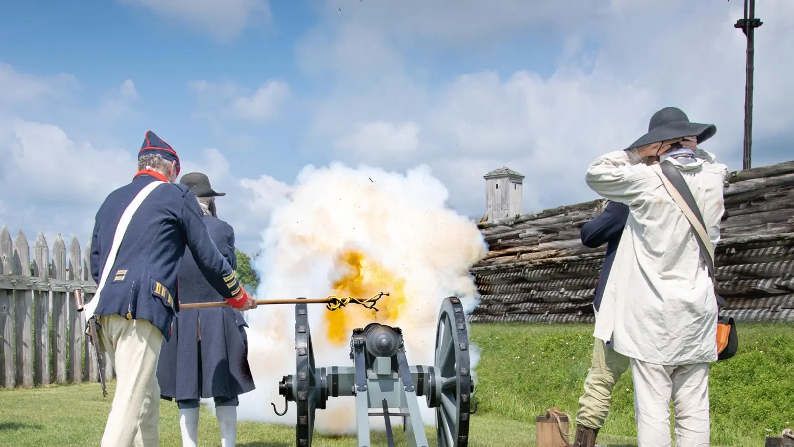 Costumed National Park Service interpreters firing a cannon inside the reconstructed Fort Stanwix in Rome, New York